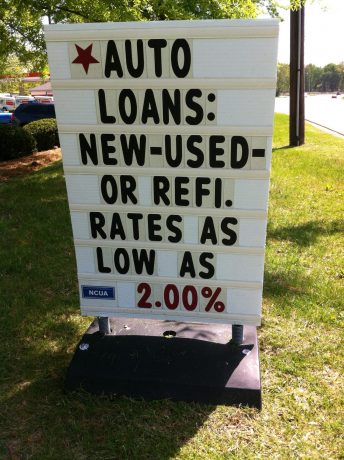 outdoor message board featuring car loan rates