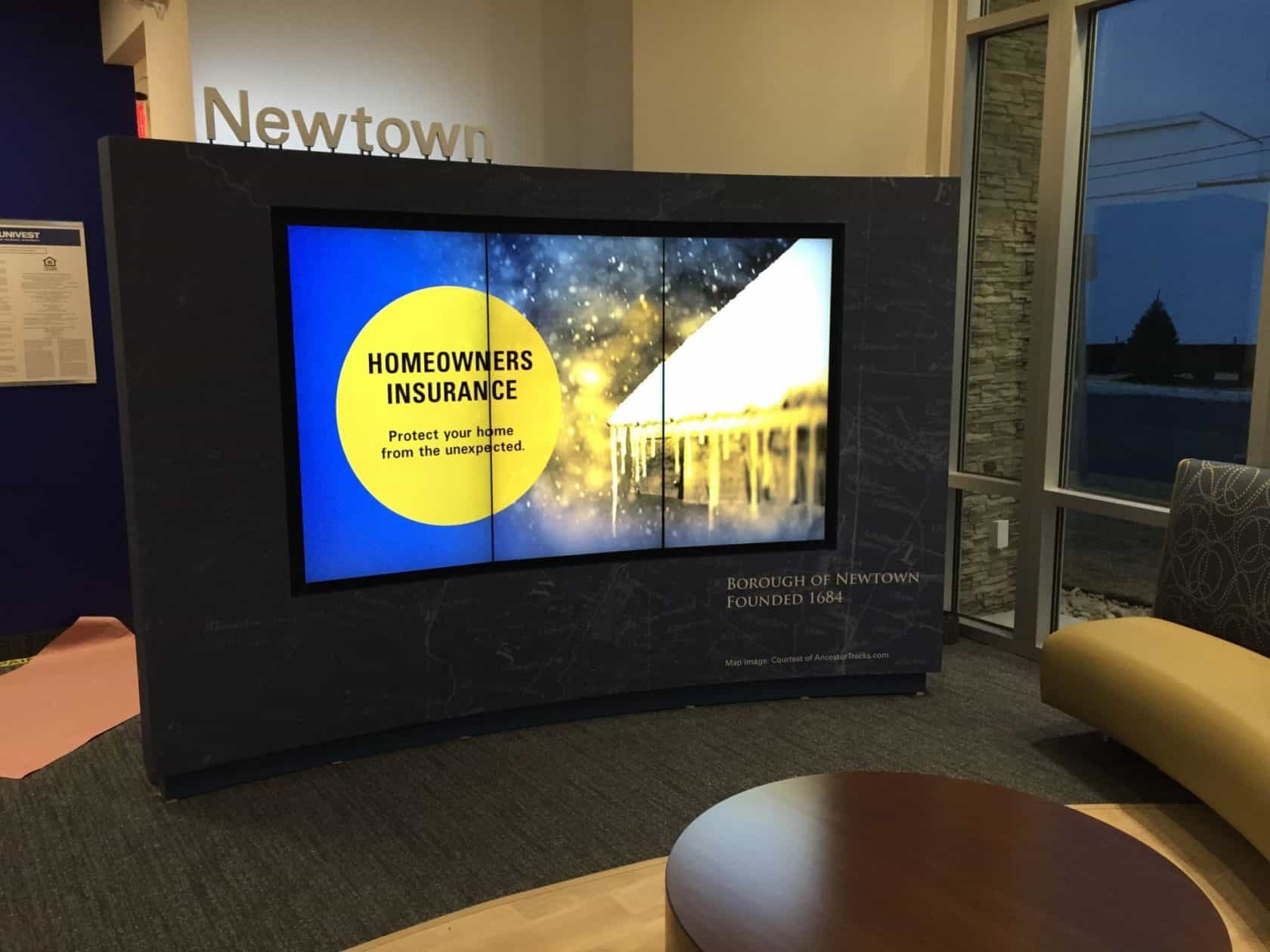 Newtown branded media wall with night time visibility.